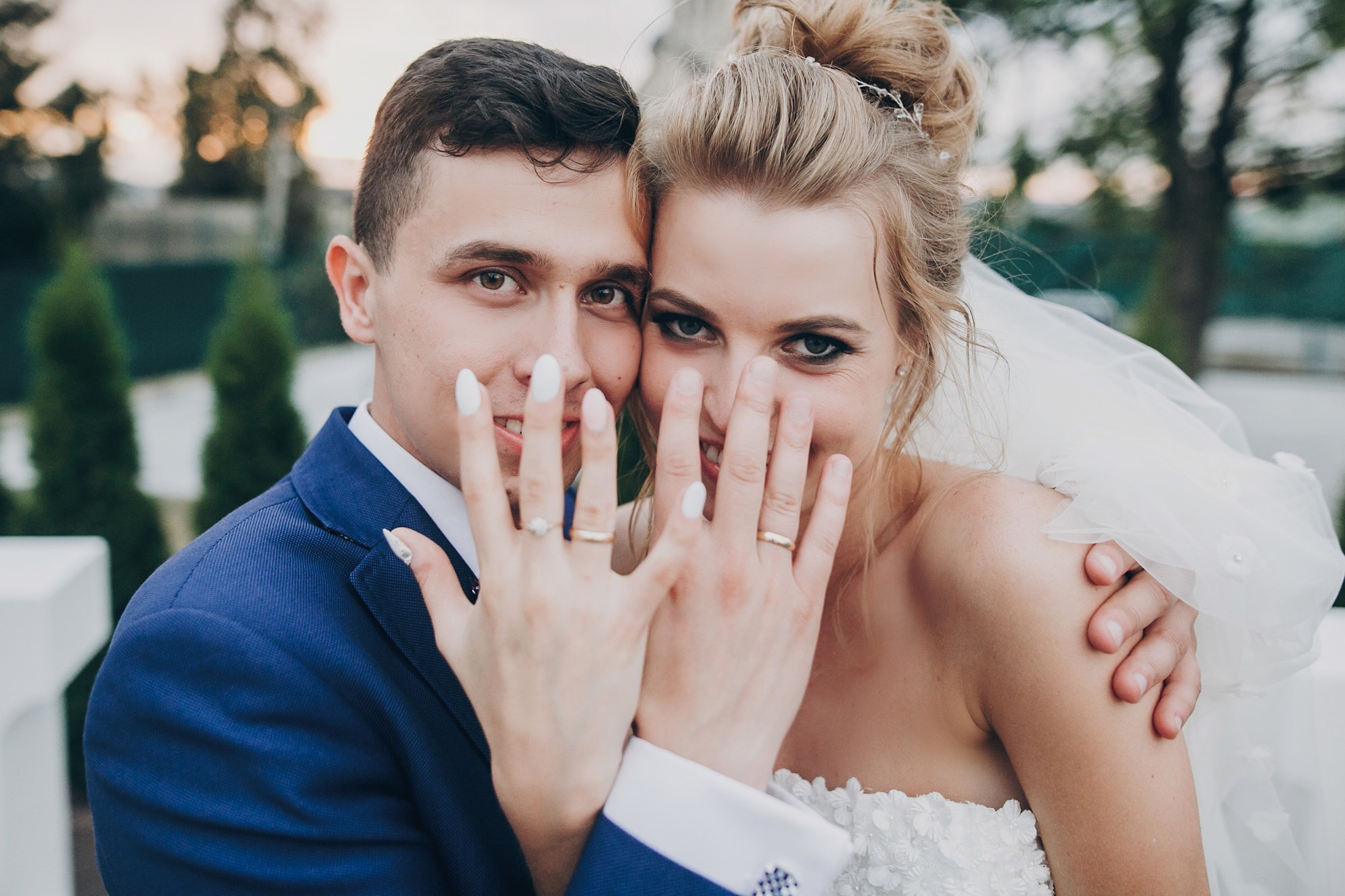 just-married-stylish-happy-bride-and-groom-showing-hands-with-wedding-rings.jpg